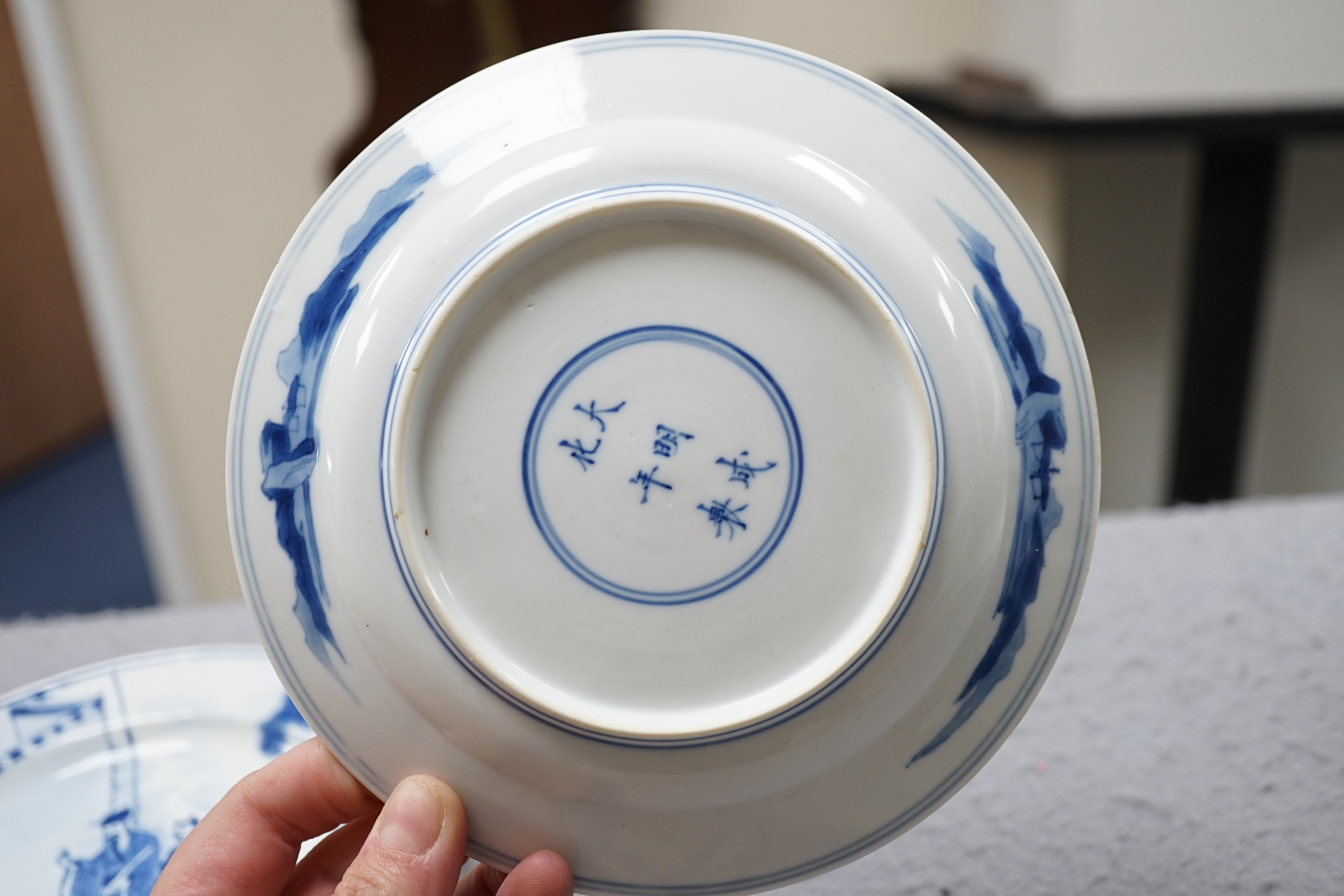 A pair of Chinese blue and white small plates, Kangxi period, hairline cracks to one plate.